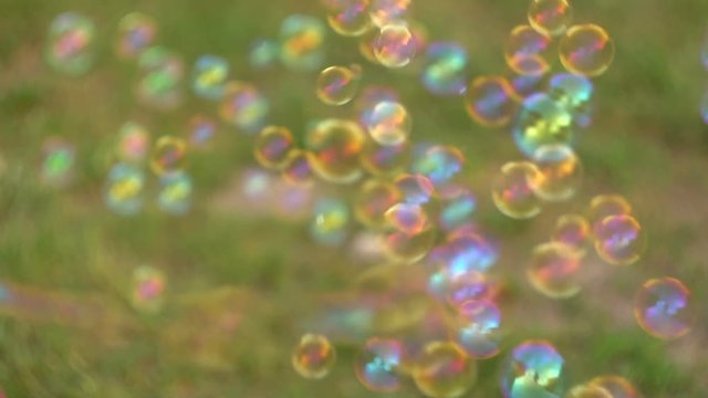 Close up of soap colorful bubbles floating in the air 