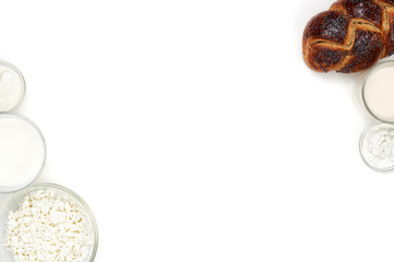 Challah bread with poppy seeds and set of dairy. Jewish holiday Shavuot concept