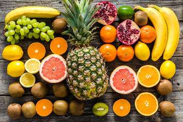 Farm table with fruits, flat lay. Fresh fruit background, healthy food and clean eating concept.