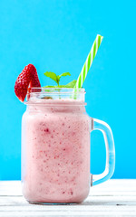 Jar of smoothie with strawberries, milk shake with fresh strawberry fruit blended with milk