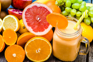 Tropical fruit smoothie with oranges and milk, shake in jar