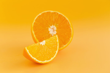 Fototapeta na wymiar Glass of orange juice freshly squeezed on an orange background