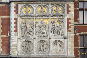 Architectural fragments of Historic building of Amsterdam central railway station (Amsterdam Centraal), Netherlands. Amsterdam Centraal's building first opened in 1889.