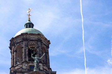 Bell Tower with Statues and Blue Sky