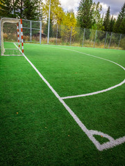 Corner of a soccer. Soccer field with green grass yard and football goal in school area. beautiful sport playground.