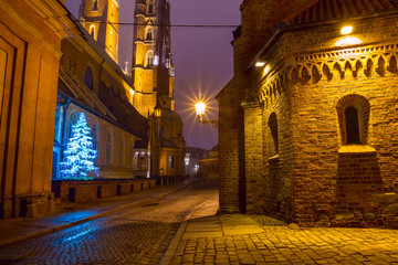 Fototapeta premium Christmas cityscape - evening view of the Cathedral of St. John the Baptist, located in the Ostrow Tumski old district of the city of Wroclaw, in Lower Silesia Province, Poland