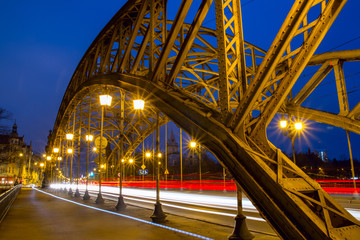 Fototapeta na wymiar Cityscape - evening view on bridge with lights moving vehicles, the Zwierzyniecki Bridge eastern part of Wroclaw, Poland