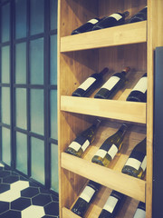 Fototapeta na wymiar Bottles of red and white wine in rows in wine shop