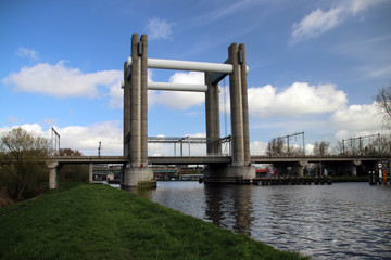 Fototapeta premium vertical lift bridge for trains in Gouda over canal named Gouwe in the Netherlands
