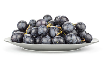 Black purple grape cluster (autumn royal variety) on a grey plate isolated on white background.