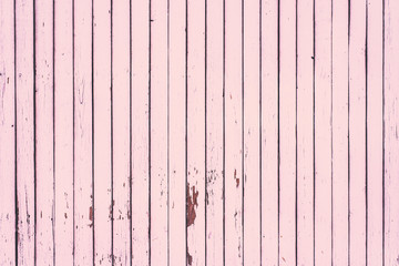 Wooden background of shabby boards painted in pink color