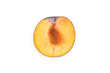 One red blue plum half top view isolated on white background cross section.