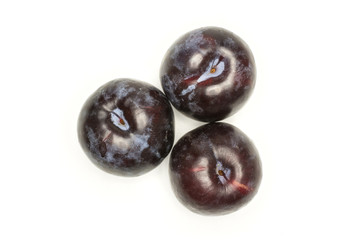 Three red blue plums top view isolated on white background round whole fresh juicy fruit.