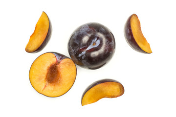 Red blue plums set top view isolated on white background one whole one section half three slices.
