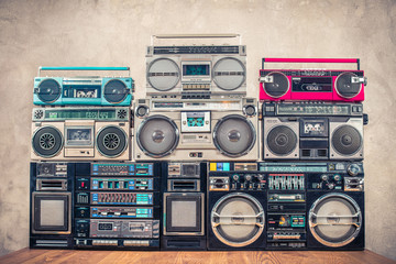 Retro old school design ghetto blaster stereo radio cassette tape recorders boombox tower from circa 1980s front concrete wall background. Vintage instagram style filtered photo - obrazy, fototapety, plakaty