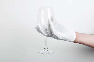 empty glass of wine in hand on a white background