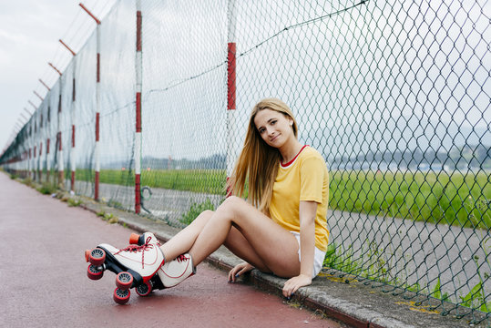 Trendy girl in roller blades on street