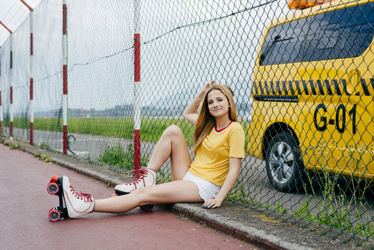 Trendy girl in roller blades on street