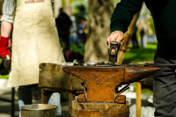 blacksmith with an anvil and a hammer on the street