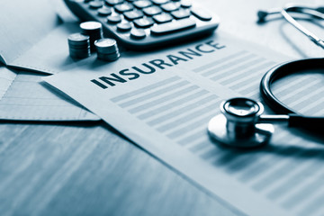 Health insurance form with money,passbook ,calculator and stethoscope concept for life planning