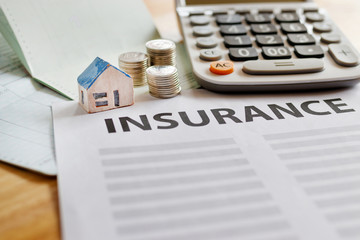 Home insurance form with money,passbook  and calculator.