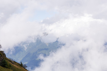 Photo of mountain slopes with cloudy sky
