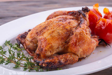 A fried quail with herbs and cherry tomatoes