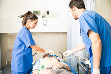 Paramedics doing ECG test on patient