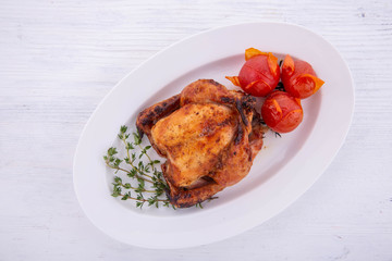 The chicken fried on a grill with caraway seeds and vegetables