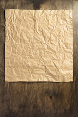 wrinkled paper at wooden  background