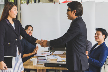 Business people are shaking hands Because they work together.