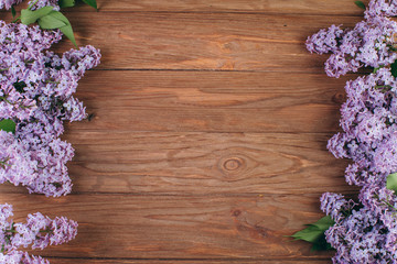 The beautiful violet lilac on a old wooden background. Flat lay and copy space composition.