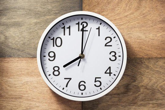 wall clock at wooden background