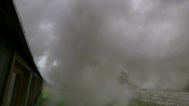 Steam above a rolling train