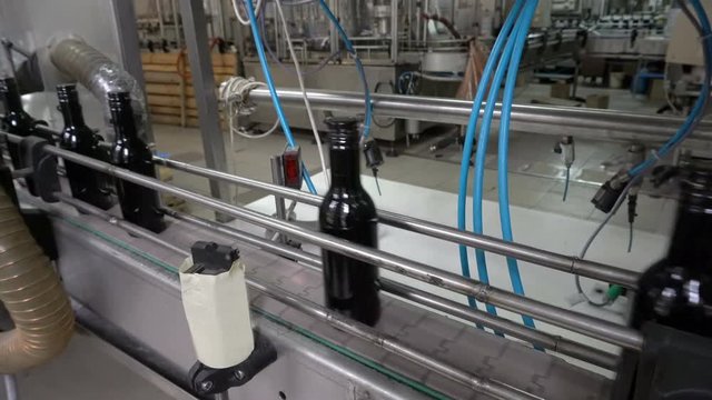 Bottling and sealing conveyor line at winery factory
