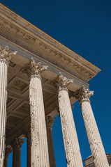 Close-up of decorative capital and frieze on the Maison Carrée's columns, an ancient Roman temple,...