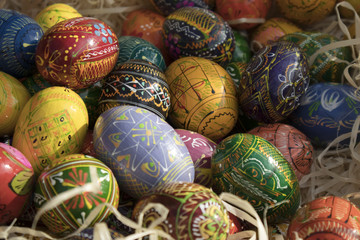 Colorful Easter wooden eggs in wooden chips shop for sale