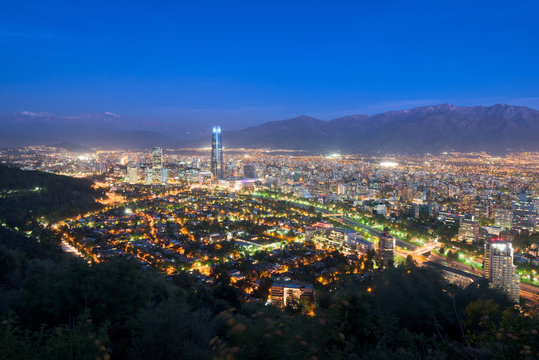 Panoramic view at night of Santiago de Chile with The Andes Mountain Range in the back