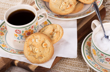 White chocolate chip macadamia nut cookies with a cup of coffee 