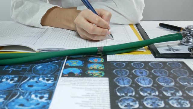 woman doctor fills a journal