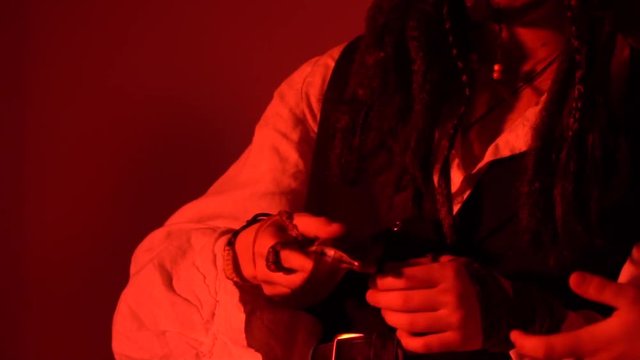 A pirate man hands over a dagger and takes out a musket