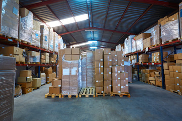 Warehouse stograge with stacked boxes in rows