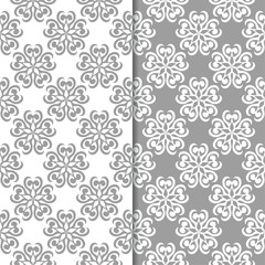 White and gray floral backgrounds. Set of seamless patterns