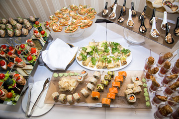 Buffet table of reception with burgers, cold snacks, meat and salads