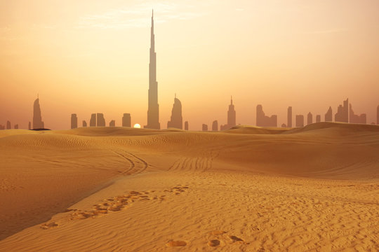 Dubai city skyline at sunset seen from the desert
