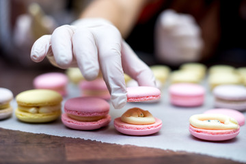 cooking, confectionery and baking concept - macarons on table