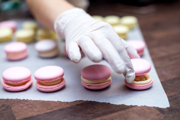 cooking, confectionery and baking concept - macarons on table