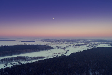 Dawn over the countryside in winter. Aerial view 