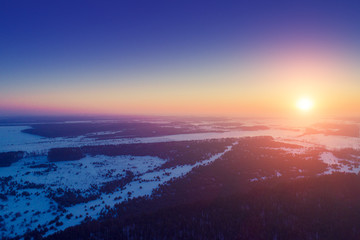 Sunset over countryside in winter. Aerial view 