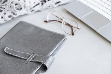 Selective focus table : Businessman hand write notebook, mobile phone, laptop, and pen on the wooden table.working Business concept with effect light added